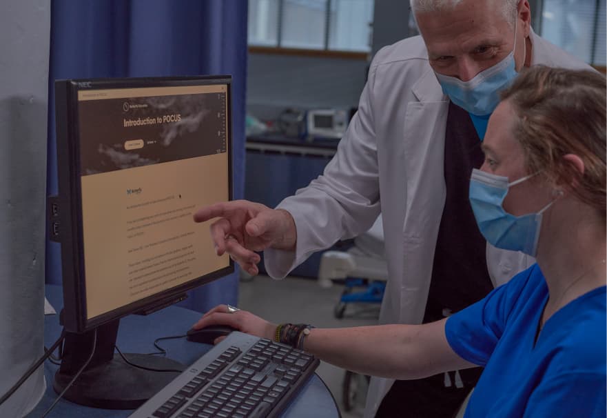 Doctor pointing at screen in a hospital